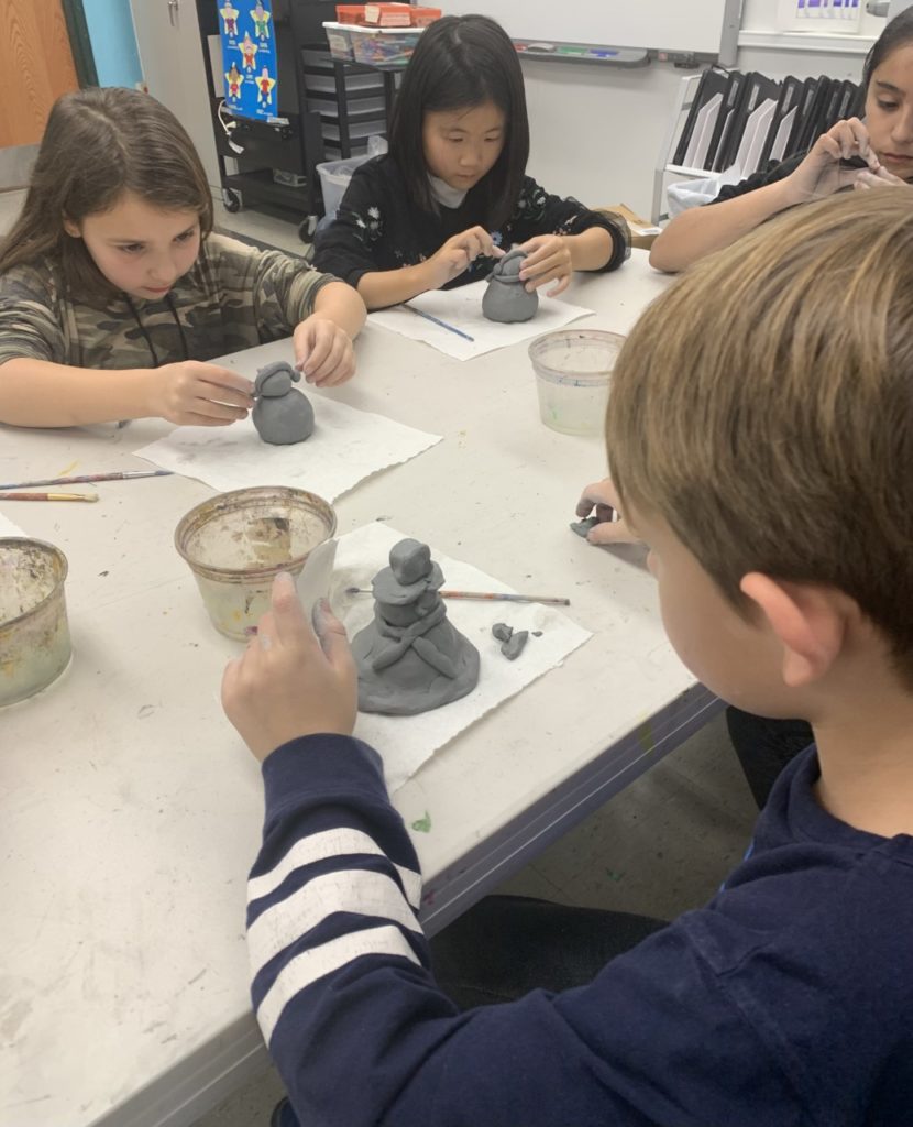 Young artists exploring their creativity through clay sculptures at the family-friendly studio